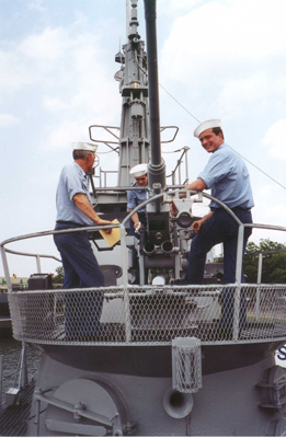 Crewmen cleaning 40mm gun